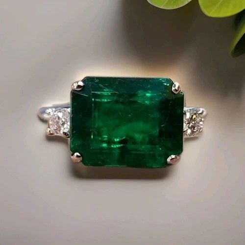 VINTAGE 14K WHITE GOLD ENGAGEMENT RING 5.00CT. NATURAL GREEN EMERALD GIA CERT.: VINTAGE 14K WHITE GOLD ENGAGEMENT RING 5.00CT. NATURAL GREEN EMERALD GIA CERT. Gorgeous vintage 14K white gold emerald ring featuring a magnificent natural emerald in an elegant emerald cut. The cente