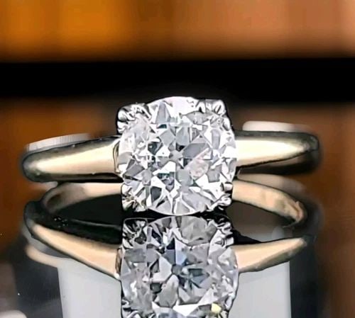 VINTAGE 18K TWO-TONE GOLD ENGAGEMENT RING 1.45CT. NATURAL OLD EURO ROUND DIAMOND: This is a vintage 18k - 14k two-tone gold engagement ring with a 1.45ct natural old euro round diamond. The ring features a cocktail style with a prong setting and is certified by AGI. The diamond col