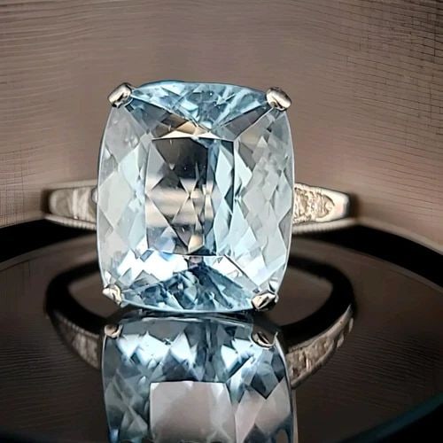 VINTAGE 14K WHITE GOLD ENGAGEMENT RING 13.55CT. NATURAL AQUAMARINE CUSHION CUT: VINTAGE 14K WHITE GOLD ENGAGEMENT RING 13.55CT. NATURAL AQUAMARINE CUSHION CUT This vintage 14k white gold ring boasts a stunning 13.55ct natural aquamarine in a cushion cut. The ring is resizable and