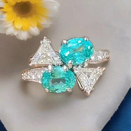 PLATINUM VINTAGE NATURAL DIAMOND RING 3.94CT OVAL NEON BLUE TOURMALINE: Platinum Vintage Natural Diamond Ring 3.94ct Oval Neon Blue Tourmaline This striking vintage cocktail ring is crafted in platinum and showcases a matched pair of lab-grown oval neon blue tourmalines t