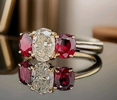 VINTAGE 14K YELLOW GOLD ENGAGEMENT RING 1.90CT NATURAL OVAL DIAMOND & RUBY: VINTAGE 14K YELLOW GOLD ENGAGEMENT RING 1.90CT NATURAL OVAL DIAMOND & RUBY This vintage 14k yellow gold engagement ring features a stunning 1.05ct oval-shaped natural diamond as the main stone, set by