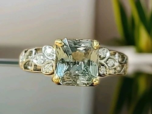 VINTAGE 14K MUTIE-TONE GOLD RING 3.59CT.NATURAL GREEN MINT SAPPHIRE RADIANT CUT: VINTAGE 14K MUTIE-TONE GOLD RING 3.59CT.NATURAL GREEN MINT SAPPHIRE RADIANT CUT This elegant vintage ring is crafted in a beautiful combination of 14K white and yellow gold, showcasing a rare and capt