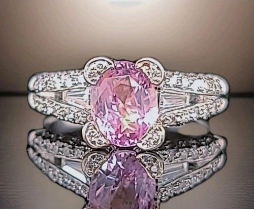 18K WHITE GOLD ENGAGEMENT RING 2.08CT.NATURAL UNTREATED PINK SAPPHIRE OVAL CUT: 18K WHITE GOLD ENGAGEMENT RING 2.08CT.NATURAL UNTREATED PINK SAPPHIRE OVAL CUT Elegant 18K white gold engagement ring featuring a natural untreated oval pink sapphire weighing 2.04 carats (8 × 6.2mm)