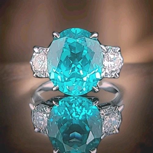 VINTAGE 14K WHITE GOLD ENGAGEMENT RING 7.48CT. NEON BLUE TOURMALINE OVAL SHAPE: VINTAGE 14K WHITE GOLD ENGAGEMENT RING 7.48CT. NEON BLUE TOURMALINE OVAL SHAPE This gorgeous vintage 14K white gold engagement ring features a stunning lab-grown Paraíba-color tourmaline in an elegan