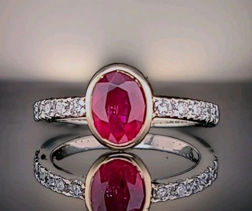 1.83CT.NATURAL OVAL RUBY 14K MULTIE TONE GOLD ENGAGEMENT VINTAGE RING BEZEL SET: 1.83CT.NATURAL OVAL RUBY 14K MULTIE TONE GOLD ENGAGEMENT VINTAGE RING BEZEL SET This elegant vintage engagement ring is crafted in 14K yellow and white gold, featuring a 1.83CT natural heated oval-cut