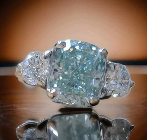 VINTAGE PLATINUM 3.49CT. BLUE MOISSANITE DIAMOND ENGAGEMENT RING CUSHION CUT: VINTAGE PLATINUM 3.49CT. BLUE MOISSANITE DIAMOND ENGAGEMENT RING CUSHION CUT Vintage platinum engagement three-stone ring. Center set gorgeous blue moissanite diamond weight 3.49CT. In cushion cut siz