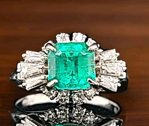 PLATINUM VINTAGE FILIGREE 1.67CT. NATURAL COLOMBIA EMERALD RING CIRC 1930'S: This exquisite vintage ring from the 1930s is a true treasure. The stunning 1.67 carat natural Colombian emerald stone is beautifully complemented by the sparkling diamonds and intricate filigree desi