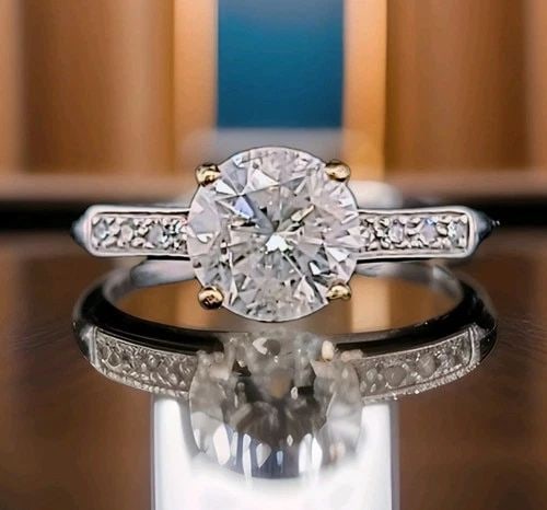 PLATINUM VINTAGE FILIGREE ENGAGEMENT RING 1.45CT. NATURAL ROUND DIAMOND 1920'S: PLATINUM VINTAGE FILIGREE ENGAGEMENT RING 1.45CT. NATURAL ROUND DIAMOND 1920'S A stunning original Art Deco ring from the 1920s, crafted in platinum with a 14K yellow gold head. The centerpiece is a 1