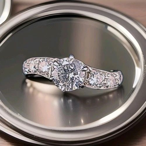 PLATINUM VINTAGE ENGAGEMENT RING 0.92CT.NATURAL ROUND DIAMOND CIRCA 1930'S: PLATINUM VINTAGE ENGAGEMENT RING 0.92CT.NATURAL ROUND DIAMOND CIRCA 1930'S This authentic Art Deco engagement ring from the 1930s features a stunning natural round white diamond approximately 0.92 car