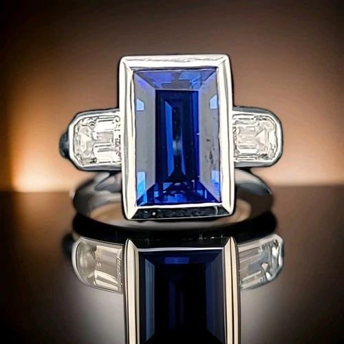14K WHITE GOLD ITALIAN DESIGN 4.65CT. GEM BLUE SAPPHIRE EMERALD SHAPE: 14K WHITE GOLD ITALIAN DESIGN 4.65CT. GEM BLUE SAPPHIRE EMERALD SHAPE Gorgeous 14k white gold blue sapphire in an emerald shape bezel setting. Center lab-grown sapphire weight 4.65ct. size 11x7mm very