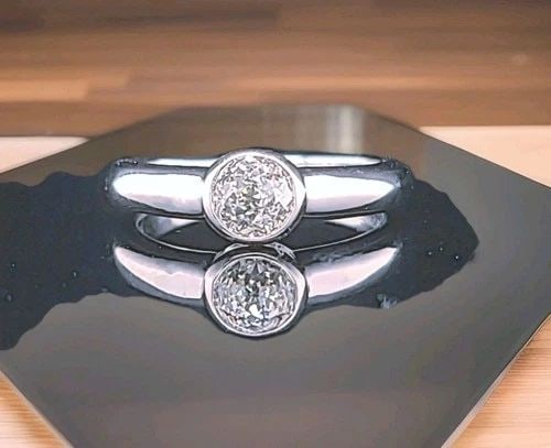VINTAGE 14K WHITE GOLD ENGAGEMENT BEZEL RING 0.75CT.NATURAL ROUND DIAMOND GIA: VINTAGE 14K WHITE GOLD ENGAGEMENT BEZEL RING 0.75CT.NATURAL ROUND DIAMOND GIA Make a heartfelt statement with this enchanting vintage engagement ring, beautifully crafted in warm 14K white gold. At it