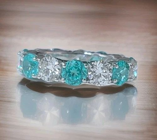 14K WHITE GOLD ETERNITY RING 11.09CT. DIAMOND BLUE NEON PARAIBA TOURMALINE ROUND: 14K WHITE GOLD ETERNITY RING 11.09CT. DIAMOND BLUE NEON PARAIBA TOURMALINE ROUND This gorgeous eternity ring is beautifully crafted in solid 14K white gold, making it a perfect choice as a wedding ban