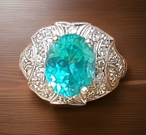 VINTAGE FILIGREE PLATINUM ENGAGEMENT RING 4.10CT. BLUE NEON TOURMALINE OVAL CUT: Vintage Filigree Platinum Engagement Ring 4.10ct. Blue Neon Tourmaline Oval Cut This exquisite vintage filigree ring showcases a 4.10-carat oval-cut lab-grown blue tourmaline (8x 10 mm) with a vibrant