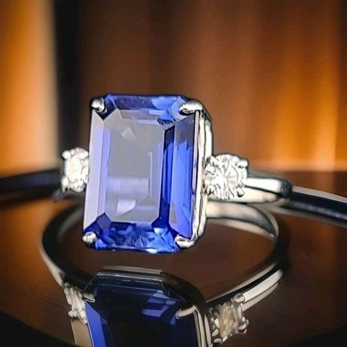14K WHITE GOLD ENGAGEMENT RING 11.05CT. GEM BLUE SAPPHIRE EMERALD SHAPE: 14K WHITE GOLD ENGAGEMENT RING 11.05CT. GEM BLUE SAPPHIRE EMERALD SHAPE Gorgeous 14k white gold engagement ring blue sapphire in an emerald shape Center lab-grown sapphire weight 11.05ct. size 14x10.3