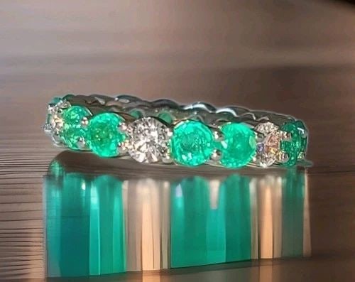 14K WHITE GOLD WEDDING ETERNITY RING 4.68CT. GREEN EMERALD DIAMOND ROUND SHAPE: 14K WHITE GOLD WEDDING ETERNITY RING 4.68CT. GREEN EMERALD DIAMOND ROUND SHAPE This stunning eternity ring is crafted in solid 14K white gold and designed as a timeless symbol of love, commitment, and