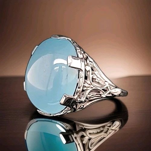 VINTAGE 14K WHITE GOLD RING 14.75CT. NATURAL BLUE CHALCEDONY OVAL SHAPE: VINTAGE 14K WHITE GOLD RING 14.76CT. NATURAL BLUE CHALCEDONY OVAL SHAPE This vintage 14K white gold ring features a beautiful oval-shaped cabochon natural blue chalcedony gemstone. The solitaire with 