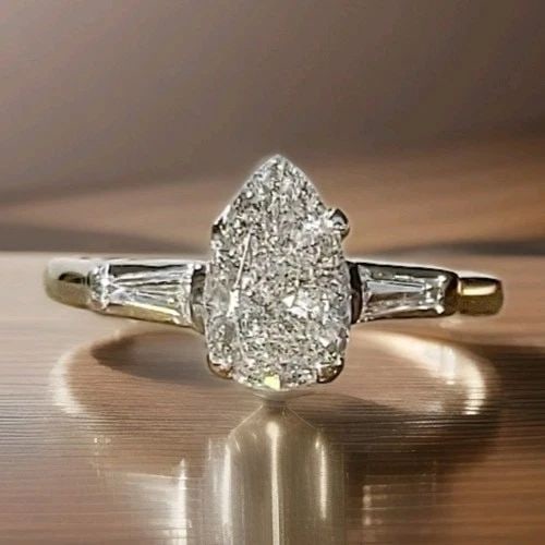 PLATINUM VINTAGE ENGAGEMENT RING 1.18CT.NATURAL PEAR SHAPE DIAMOND CIRC 1940'S: PLATINUM VINTAGE ENGAGEMENT RING 1.18CT.NATURAL PEAR SHAPE DIAMOND CIRC 1940'S This stunning vintage engagement ring is masterfully crafted in solid platinum and showcases a captivating 1.18 carat nat