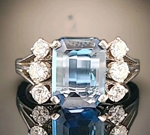 VINTAGE 18K WHITE GOLD ENGAGEMENT RING 2.02CT. NATURAL AQUAMARINE EMERALD SHAPE: VINTAGE 18K WHITE GOLD ENGAGEMENT RING 2.02CT. NATURAL AQUAMARINE EMERALD SHAPE This vintage 18k white gold engagement ring is a true gem, featuring a stunning 2.02ct natural aquamarine gemstone in an