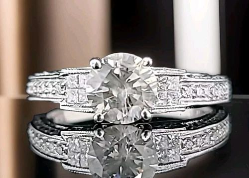 VINTAGE 18K WHITE GOLD ENGAGEMENT RING 1.20CT. NATURAL ROUND LIGHT GRAY DIAMOND: VINTAGE 18K WHITE GOLD ENGAGEMENT RING 1.20CT. NATURAL ROUND LIGHT GRAY DIAMOND This vintage 18k white gold engagement ring is a stunning piece that will make any occasion special. The ring features a