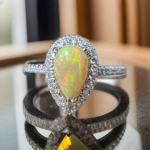 14K WHITE GOLD ENGAGEMENT RING 1.78CT. NATURAL AUSTRALIAN OPAL PEAR SHAPE: 14K WHITE GOLD ENGAGEMENT RING 1.78CT. NATURAL AUSTRALIAN OPAL PEAR SHAPE 14K WHITE GOLD OPAL ENGAGEMENT RING CENTER SET NATURAL OPAL PEAR SHAPE CABOCHON WEIGHT 1.78CARAT SIZE 10x6MM NATURAL OPAL GORG