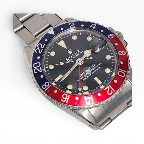 ROLEX GMT MASTER 40MM STEEL PEPSI BEZEL BLUE RED AUTOMATIC WATCH 1675 CIRCA 1972: ROLEX GMT MASTER 40MM STEEL PEPSI BEZEL BLUE RED AUTOMATIC WATCH 1675 CIRCA 1972 Manufacturer Rolex Category GMT Master Subcategory Plastic Crystal Reference Number 1675 Additional Keywords PEPSI BEZE