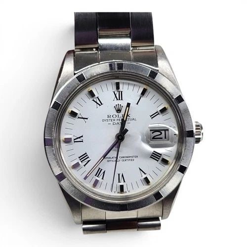 ROLEX DATE 34 MM STEEL WHITE ROMAN OYSTER AUTOMATIC WATCH 15010 CIRCA 1984: ROLEX DATE 34 MM STEEL WHITE ROMAN OYSTER AUTOMATIC WATCH 15010 CIRCA 1984 Manufacturer Rolex Category Mens Date 34mm Subcategory Plastic Crystal Quick Set Reference Number 15010 Band Stainless Steel 