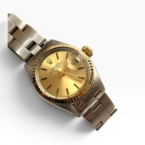 ROLEX LADIES DATE 26MM TWO TONE CHAMPAGNE OYSTER AUTOMATIC WATCH 6917 CIRCA 1978: ROLEX LADIES DATE 26MM TWO TONE CHAMPAGNE OYSTER AUTOMATIC WATCH 6917 CIRCA 1978 Manufacturer Rolex Category Oyster Perpetual Ladies Date Reference Number 6917 Band Stainless Steel Band Color Steel Ba