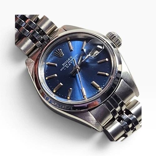 ROLEX LADIES DATE 26 MM BLUE DIAL JUBILEE STEEL AUTOMATIC WATCH 6916 CIRCA 1973: ROLEX LADIES DATE 26 MM BLUE DIAL JUBILEE STEEL AUTOMATIC WATCH 6916 CIRCA 1973 Manufacturer Rolex Category Oyster Perpetual Ladies Date Reference Number 6916 Band Stainless Steel Band Color Steel Ban
