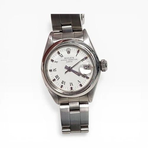 ROLEX LADIES DATE 26 MM STEEL WHITE ROMAN OYSTER AUTOMATIC WATCH 6916 CIRCA 1973: ROLEX LADIES DATE 26 MM STEEL WHITE ROMAN OYSTER AUTOMATIC WATCH Manufacturer Rolex Category Oyster Perpetual Ladies Date Reference Number 6916 Band Stainless Steel Band Color Steel Band Type Oyster B
