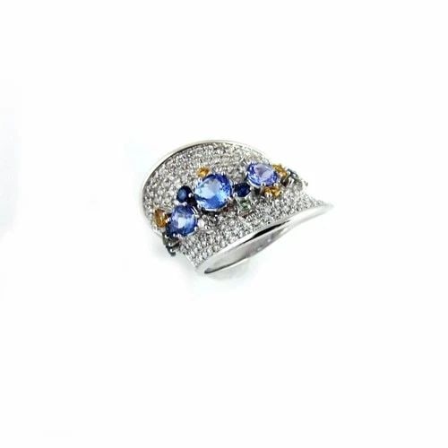 TANZANITE DIAMOND GOLD RING LARGE CONTOUR STYLE: TANZANITE DIAMOND GOLD RING LARGE CONTOUR STYLE This Diamond & Tanzanite Gold Ring in a large fan style is a stunning piece of fine jewelry perfect for an anniversary occasion. The ring features a bea