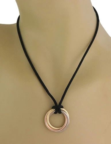 CARTIER NECKLACE TRINITY 18K TRICOLOR GOLD INTERLACED PENDANT & CORD PAPER: CARTIER NECKLACE TRINITY 18K TRICOLOR GOLD INTERLACED PENDANT & CORD PAPER The Cartier Necklace Trinity 18k Tricolor Gold Interlaced Pendant & Cord is a stylish and elegant piece of fine jewelry from 