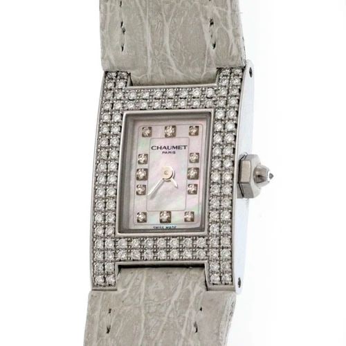 CHAUMET LADIES WATCH PARIS DIAMOND DIAL BEZEL MOP 18K WHITE GOLD QUARTZ: The Chaumet Ladies Watch Paris features a luxurious design with a white mother of pearl dial, diamond markers, and a sparkling diamond bezel. This elegant timepiece is crafted from 18k white gold with