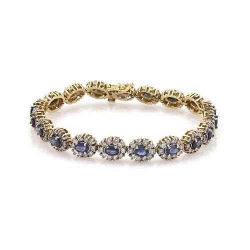 DIAMOND GOLD BRACELET 14K YELLOW OVAL HALO FLORAL LINK: DIAMOND GOLD BRACELET 14K YELLOW OVAL HALO FLORAL LINK This Diamond Gold Bracelet features a beautiful oval-shaped diamond set in 14k multi-tone gold. The bracelet is 7 inches in length and has a tenn