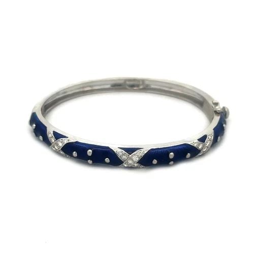 HIDALGO DIAMOND GOLD BANGLE BLUE ENAME 18K WHITE HINGED X DESIGN OVAL SHAPE: HIDALGO DIAMOND GOLD BANGLE BLUE ENAME 18K WHITE HINGED X DESIGN OVAL SHAPE The Hidalgo gold bangle features a stunning oval shape; it is hinged on one end with slide closure on the other side. The ba