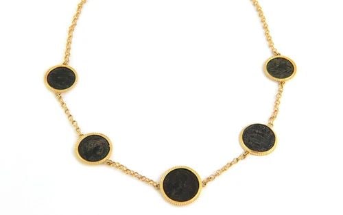 COIN NECKLACE 22KT GOLD WITH FIGURE ESTATE: COIN NECKLACE 22KT GOLD WITH FIGURE ESTATE This Coin Necklace is a luxurious piece of fine jewelry made of 22kt yellow gold. The pendant shape of the necklace is unique as it is designed in the form o