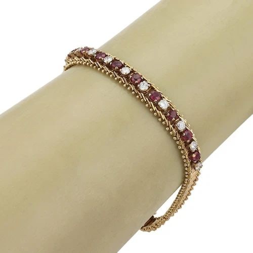 DIAMOND & RUBY GOLD BRACELET14K YELLOW FLEXIBLE BAND VINTAGE: DIAMOND & RUBY GOLD BRACELET14K YELLOW FLEXIBLE BAND VINTAGE Vintage Diamond Ruby 14k Yellow Gold 7.5mm Wide Tennis Bracelet Description This lovely vintage bracelet is crafted from 14k yellow gold wi
