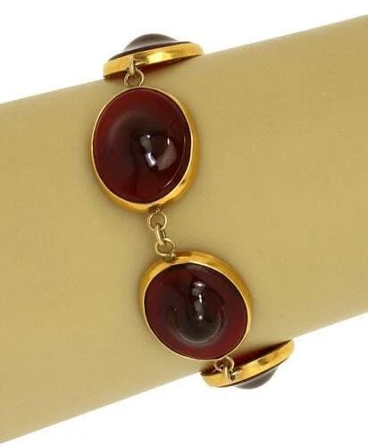 YELLOW GOLD BRACELET 14K YELLOW HANDBLOWN RED GLASS ROUND LINK STYLE: YELLOW GOLD BRACELET 14K YELLOW HANDBLOWN RED GLASS ROUND LINK STYLE This product is a vintage yellow gold bracelet featuring handblown red glass in round gold links. The bracelet has a length of 7.75