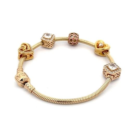 PANDORA 14K GOLD 5 SLIDE CHARMS SNAKE CHAIN BRACELET: PANDORA 14K GOLD 5 SLIDE CHARMS SNAKE CHAIN BRACELET This authentic and charming bracelet is by Pandora, crafted from 14k yellow gold featuring a 3mm thick snake cable bracelet with 5 assorted style c