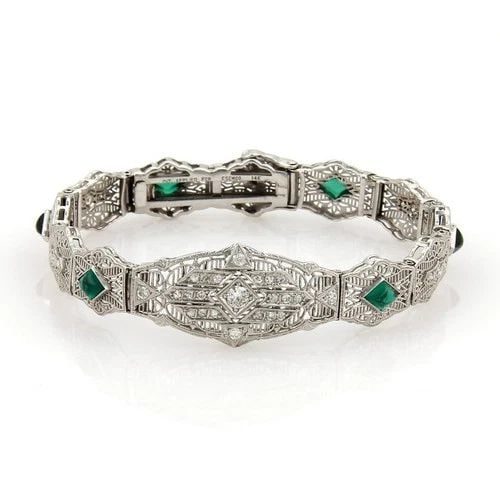 ART DECO DIAMOND BRACELET 14K WHITE GOLD FILIGREE LINK: ART DECO DIAMOND BRACELET 14K WHITE GOLD FILIGREE LINK This Art Deco diamond bracelet is crafted from 14k white gold with intricate filigree links, exuding elegance and sophistication. The bracelet fe