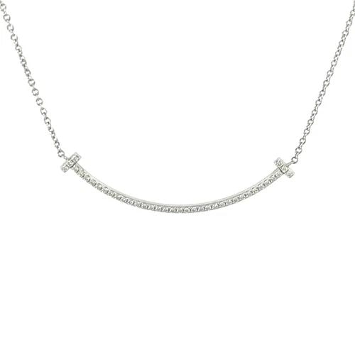 TIFFANY & CO. T SMILE DIAMOND PENDANT, SMALL 18K WHITE GOLD CHAIN RETAIL $3450: TIFFANY & CO. T SMILE DIAMOND PENDANT, SMALL 18K WHITE GOLD CHAIN RETAIL $3450 Add a touch of elegance to any outfit with this Tiffany & Co. T Smile diamond pendant, crafted in lustrous 18k white gold