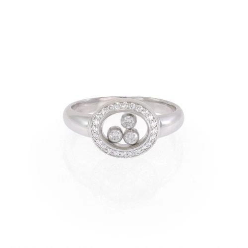 CHOPARD RING HAPPY DIAMOND 18K WHITE GOLD OVAL DIAMOND BEZEL: The Chopard Ring Happy Diamond is a luxurious piece of fine jewelry crafted with 18k white gold. The oval diamond bezel setting showcases three round diamonds, floating elegantly in the design. Signed