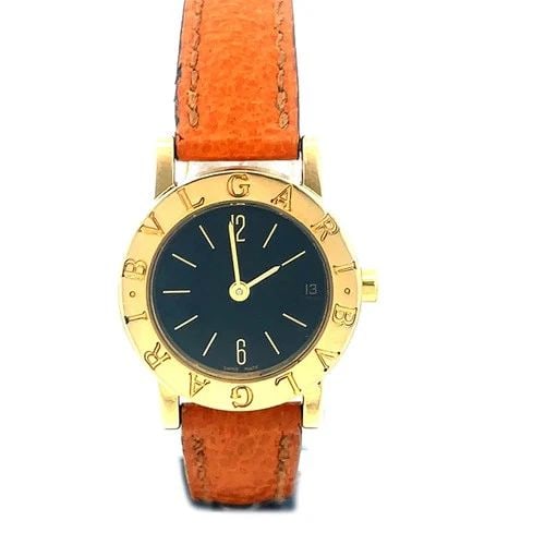 BVLGARI GOLD WOMEN'S WATCH 18K YELLOW SIGNATURE BLACK DIAL SMALL SIZE BB23GL: The Bvlgari yellow gold women's wristwatch is a luxurious timepiece featuring an 18k yellow gold bezel and case, with a black dial and brown leather two-piece strap. The watch has a quartz movement an