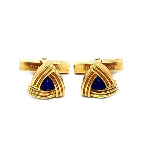 IFFANY & CO. GOLD LAPIS CUFFLINKS 18K YELLOW TRILLION SHAPE STYLE: IFFANY & CO. GOLD LAPIS CUFFLINKS 18K YELLOW TRILLION SHAPE STYLE The product is a pair of 18k yellow gold cufflinks from Tiffany & Co., featuring a unique trillion shape grooved style frame and a lap