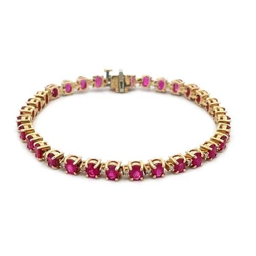 RUBY DIAMOND GOLD BRACELET 14K YELLOW PRONG SET TENNIS STYLE: RUBY DIAMOND GOLD BRACELET 14K YELLOW PRONG SET TENNIS STYLE This beautiful ruby bracelet is a fine piece of jewelry; it features prong set oval shaped natural ruby gemstones accented by small round s