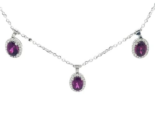 DIAMOND GOLD OVAL CHARMS NECKLACE 18K WHITE GEMSTONES HALO: DIAMOND GOLD OVAL CHARMS NECKLACE 18K WHITE GEMSTONES HALO This is a gorgeous necklace with 5 motifs, it is crafted from 18k white gold featuring dangling oval shape frame with a purplish oval gemston