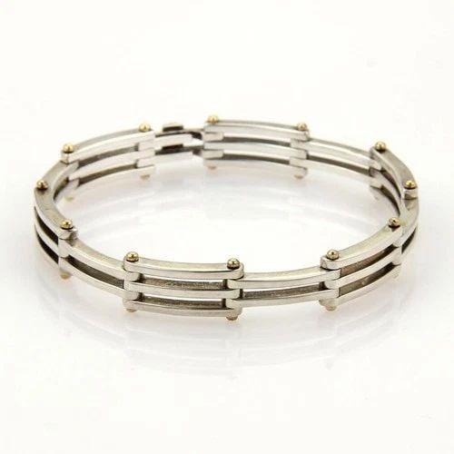 TIFFANY & CO. GATELINK BRACELET STERLING SILVER 18K YELLOW GOLD SECTION LINK: TIFFANY & CO. GATELINK BRACELET STERLING SILVER 18K YELLOW GOLD SECTION LINK This authentic Tiffany & Co. piece is finely crafted from sterling silver and 18k yellow gold. It features a beautiful flex