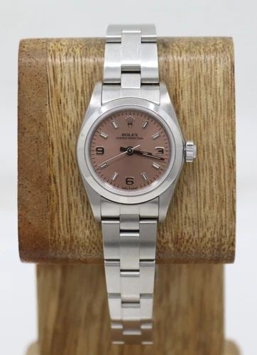 ROLEX OYSTER PERPETUAL 25MM SALMON PINK DIAL SMOOTH BEZEL WATCH 76080: ROLEX OYSTER PERPETUAL 25MM SALMON PINK DIAL SMOOTH BEZEL WATCH 76080 Description Rolex Oyster Perpetual 25mm Salmon Pink Dial Smooth Bezel Oyster Band Watch 76080 The watch has been used previously. 