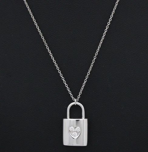 TIFFANY & CO. DIAMOND 18K WHITE GOLD PADLOCK PENDANT & CHAIN NECKLACE 16": TIFFANY & CO. DIAMOND 18K WHITE GOLD PADLOCK PENDANT & CHAIN NECKLACE 16" Description Tiffany & Co. Diamond 18k White Gold Padlock Pendant & Chain Necklace 16" Necklace/pendant is in good condition. M
