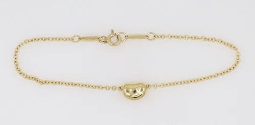 TIFFANY & CO. ELSA PERETTI 18K YELLOW GOLD BEAN BRACELET: TIFFANY & CO. ELSA PERETTI 18K YELLOW GOLD BEAN BRACELET Description Tiffany & Co. Elsa Peretti 18K Yellow Gold Bean Bracelet Bracelet is in good condition. May show signs of wear. APPROXIMATE MEASURE