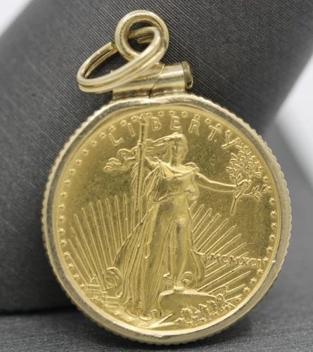 1991 $5 AMERICAN GOLD EAGLE 1/10 OZ COIN IN 14K PENDANT: 1991 $5 AMERICAN GOLD EAGLE 1/10 OZ COIN IN 14K PENDANT Description 1991 $5 American Gold Eagle 1/10 oz Coin in 14k Pendant Coin/pendant is in good condition. Shows signs of wear. APPROXIMATE MEASUREM